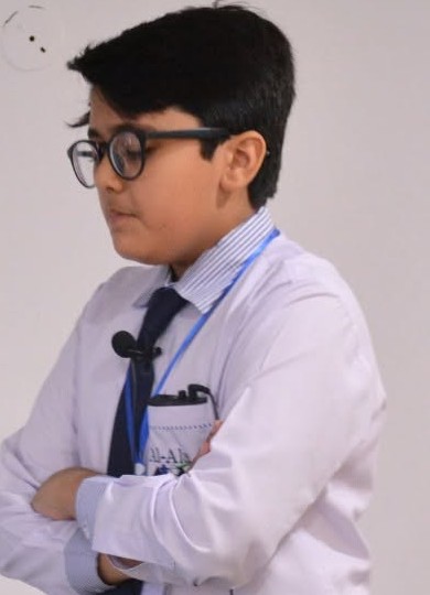Muhammad bin Asad in school uniform, speaking to his class